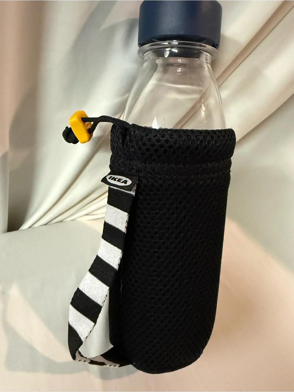 IKEA Clear Water Bottle with Blue Lid and Black Mesh Carrier